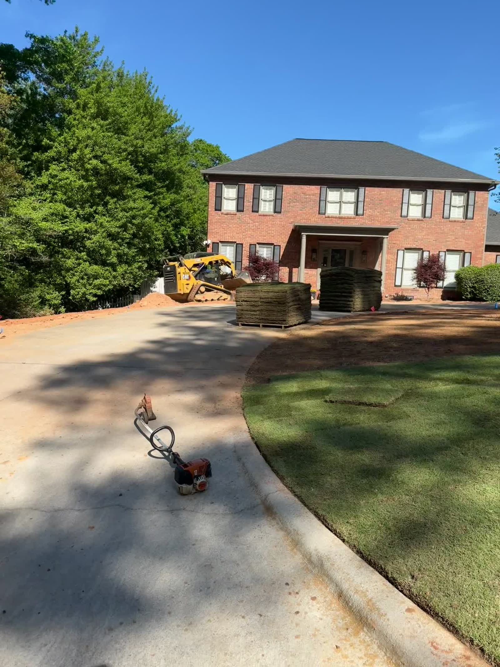 Full front yard sod installation at a two-story brick home